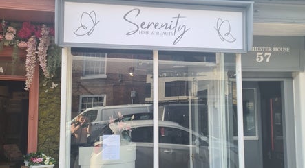 Front of Serenity Hair & Beauty, Alcester, England, GB with stylish signage and floral decor.