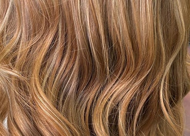 Close-up of wavy, golden hair styled at Serenity Hair & Beauty in Alcester, England, GB.