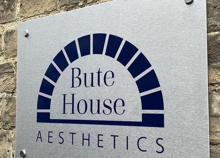 Bute House Aesthetics sign on a brick wall in Newmarket, England, GB.