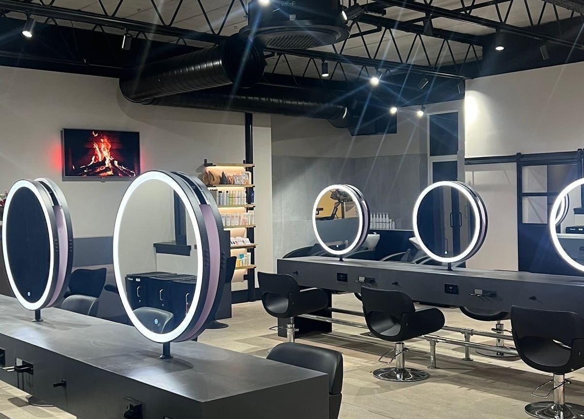 Modern stylist stations at Calum Maguire Hairdressing, Ayr, Scotland, GB, featuring round illuminated mirrors.