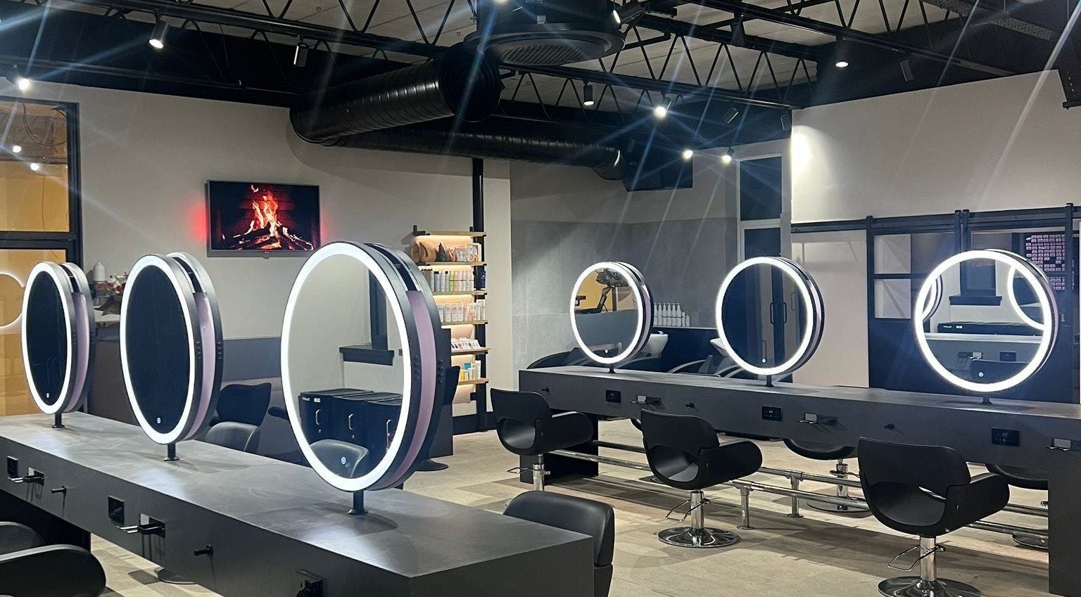 Modern stylist stations at Calum Maguire Hairdressing, Ayr, Scotland, GB, featuring round illuminated mirrors.