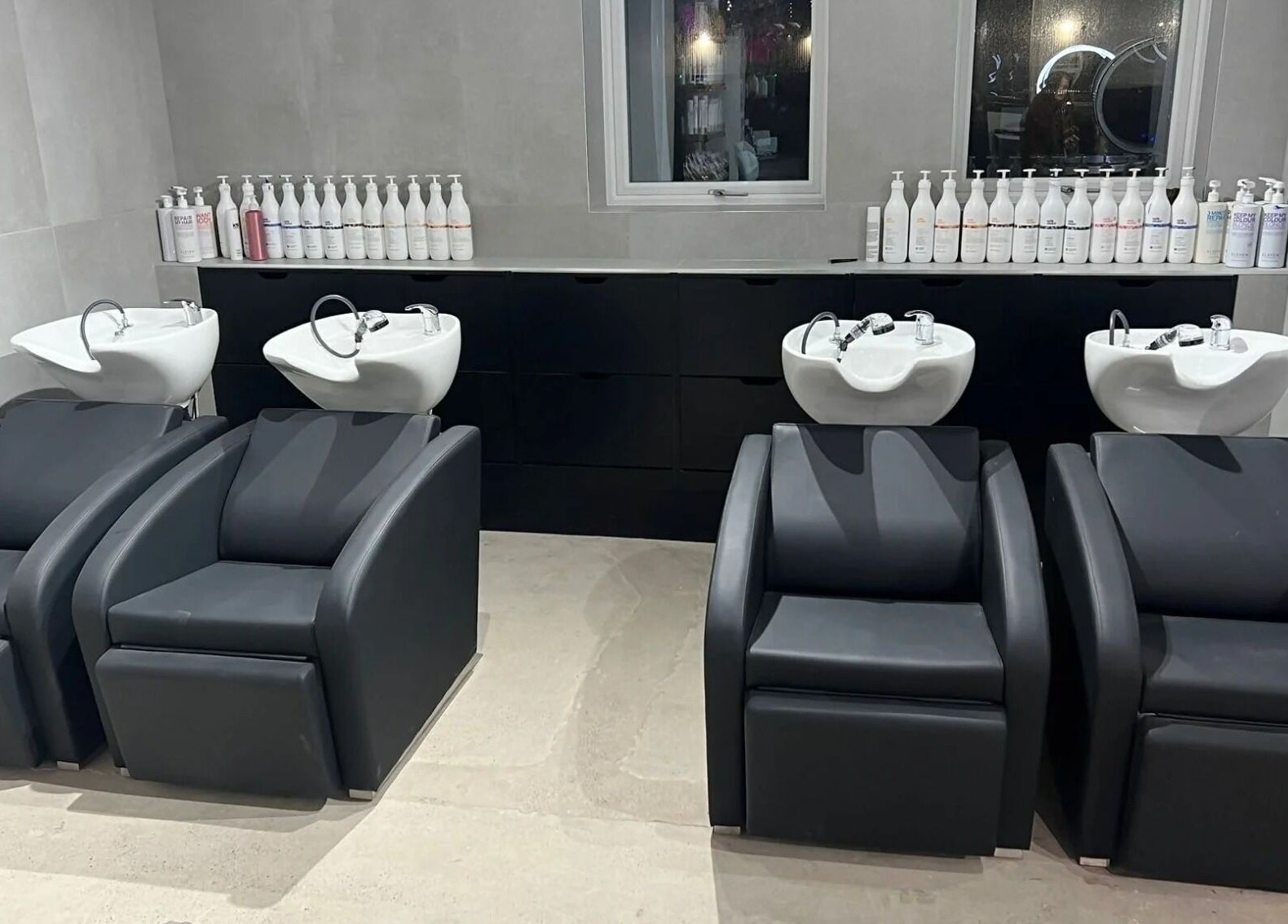 Modern wash stations at Calum Maguire Hairdressing in Ayr, Scotland, GB, showcasing chic salon interior.
