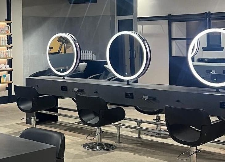 Modern styling stations at Calum Maguire Hairdressing, Ayr, Scotland, GB showcasing sleek design and elegance.