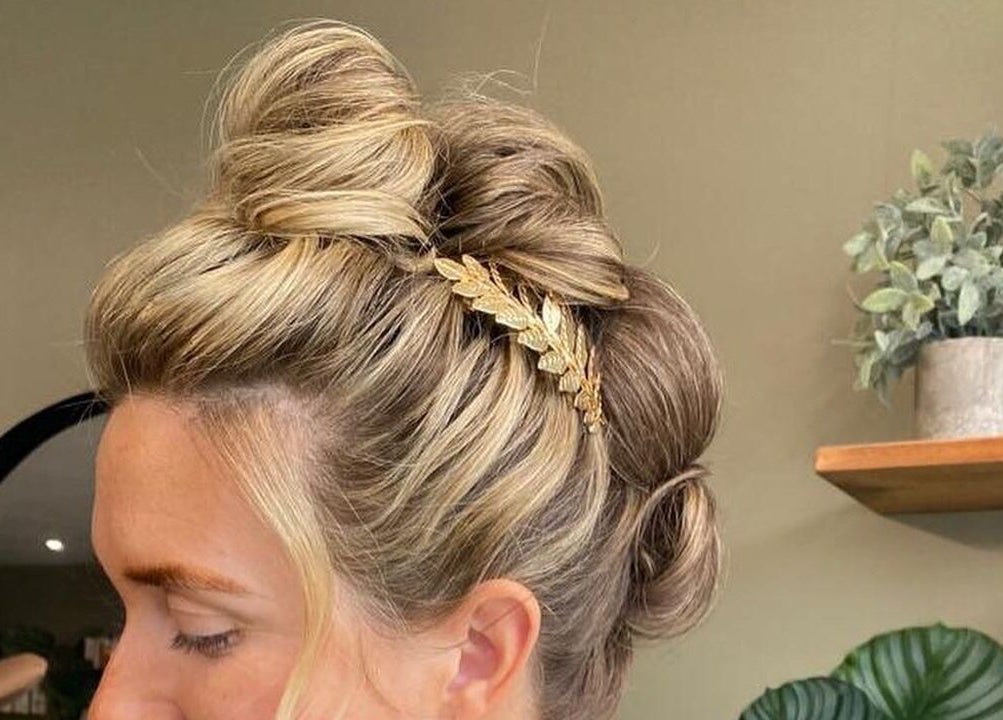 Elegant blonde updo with gold accessory at Calum Maguire Hairdressing, Ayr, Scotland, GB.