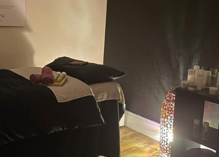Cozy treatment room at The Secret Spa in Tarleton, England, GB with a massage table and soothing ambiance.