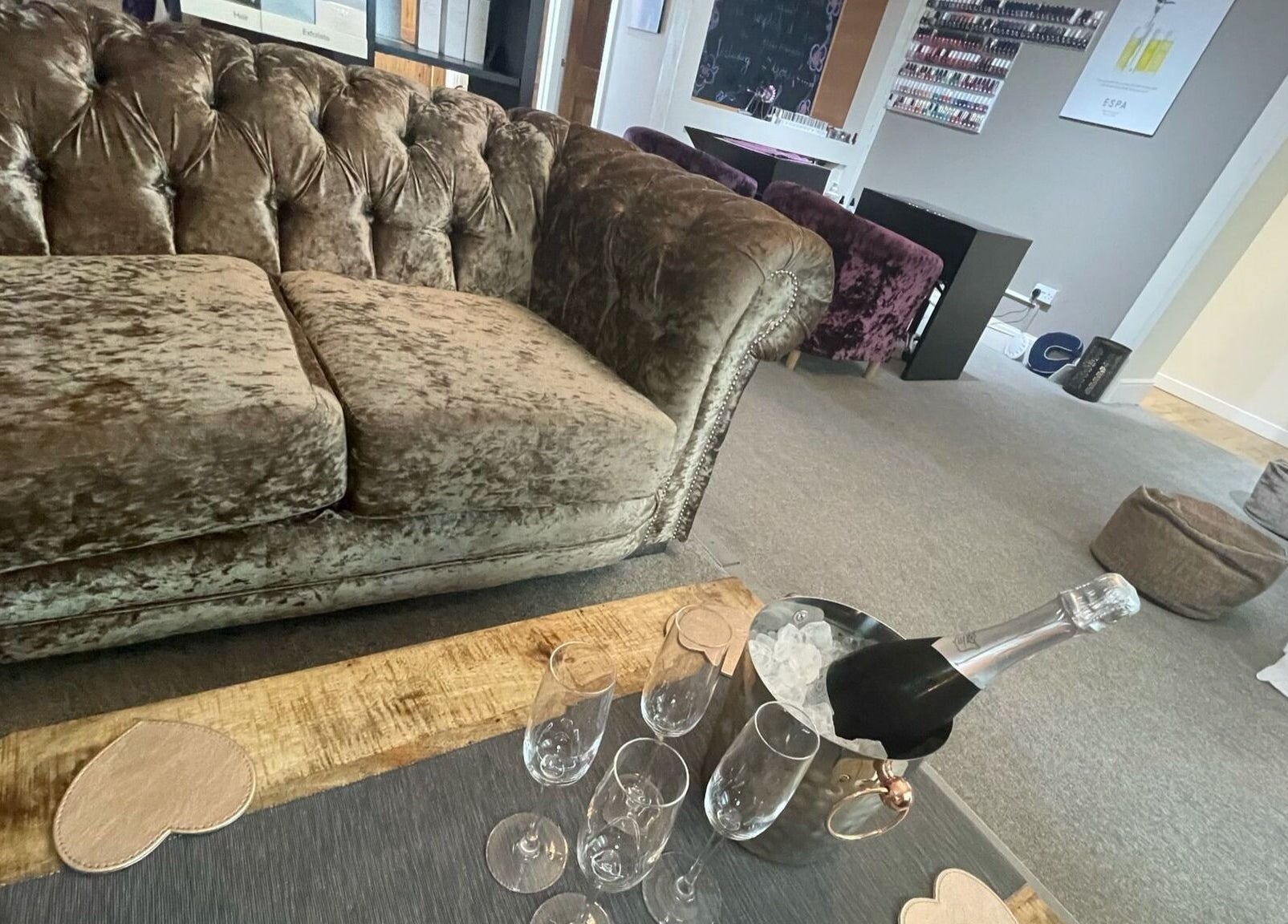 Elegant seating area at The Secret Spa, Tarleton, England, GB with plush sofa and champagne setup.