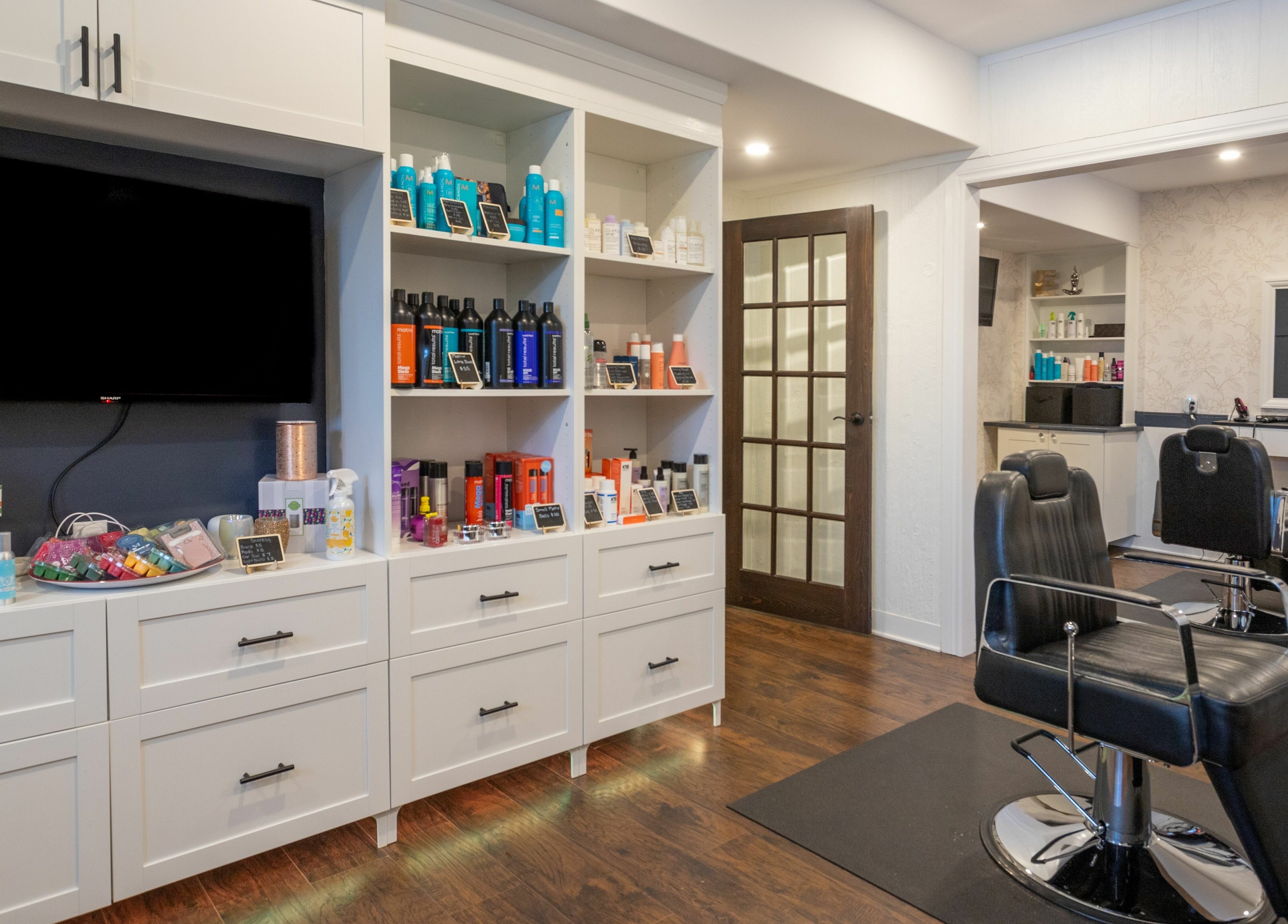 Erin’s Hair Design salon in Bradford West Gwillimbury, Ontario, CA, featuring stylish chairs and product displays.