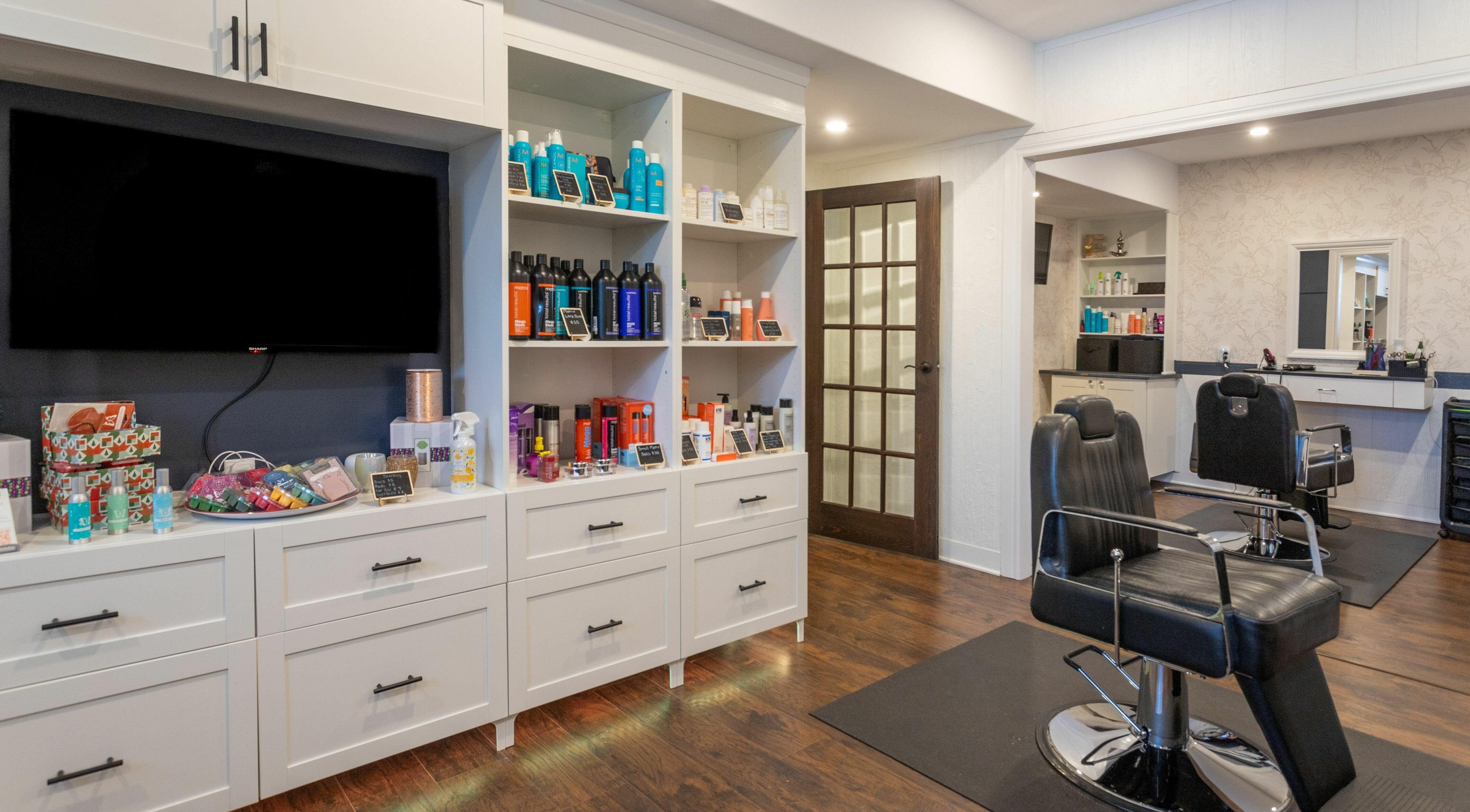 Erin’s Hair Design salon in Bradford West Gwillimbury, Ontario, CA, featuring stylish chairs and product displays.