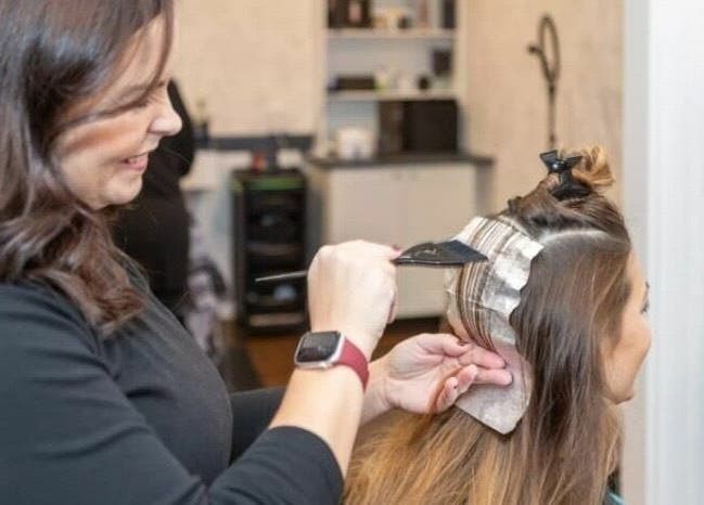 Stylist applying hair color at Erin’s Hair Design, Bradford West Gwillimbury, Ontario, CA.