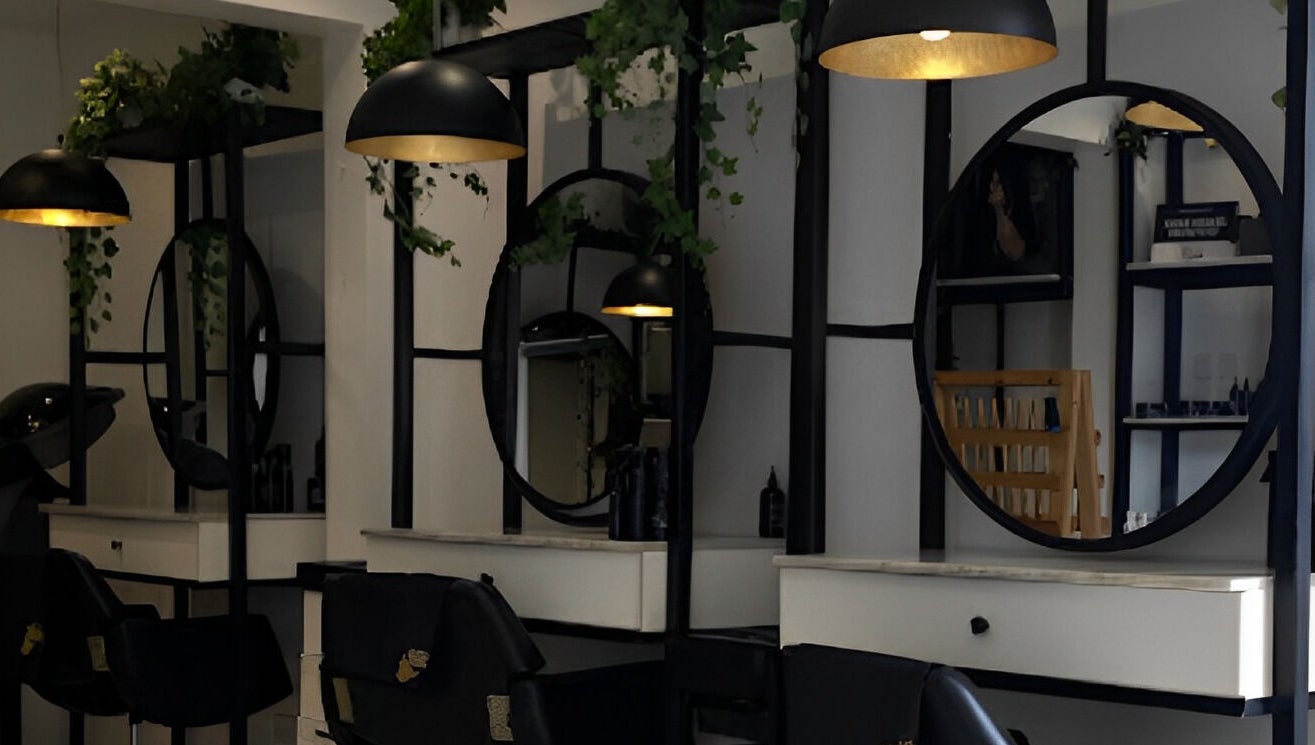 Elegant salon interior at The Braiding Vault in Lekki, Lagos, NG featuring sleek mirrors and modern lighting.