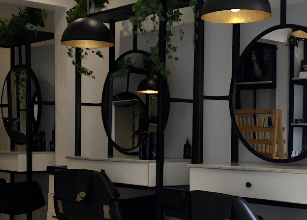 Elegant salon interior at The Braiding Vault in Lekki, Lagos, NG featuring sleek mirrors and modern lighting.