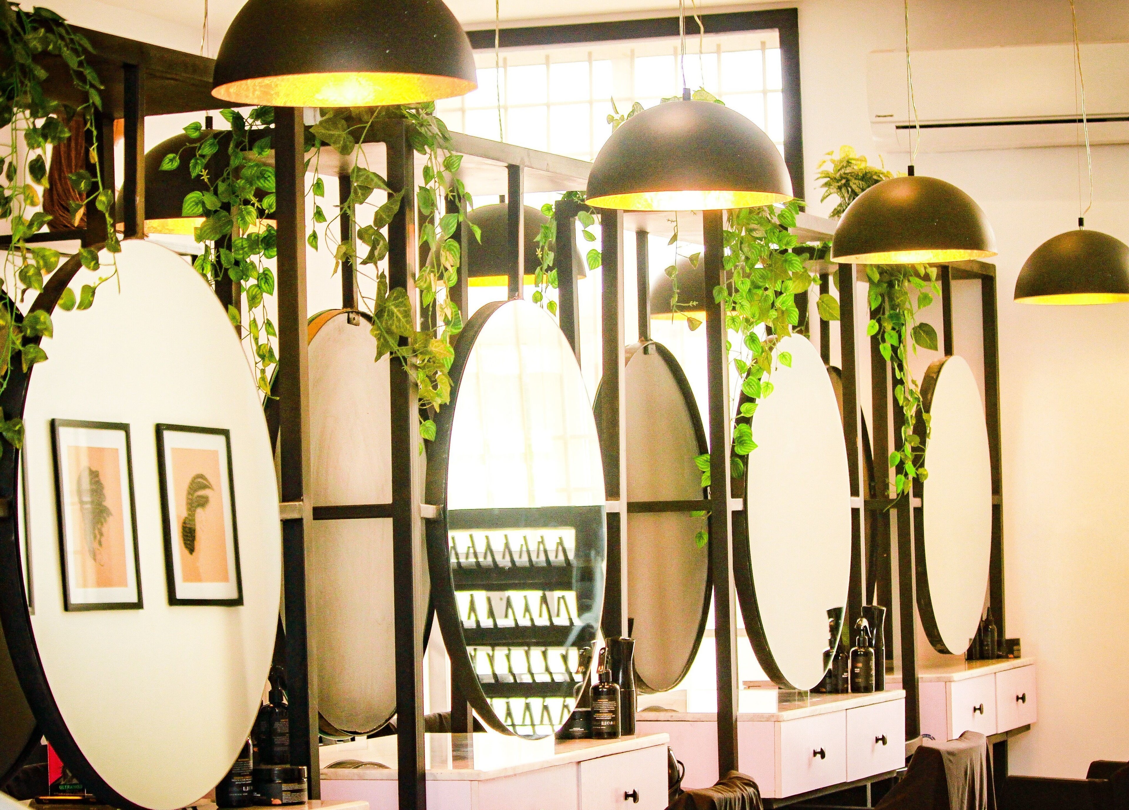Chic salon interior with mirrors and greenery at The Braiding Vault, Lekki, Lagos, NG.