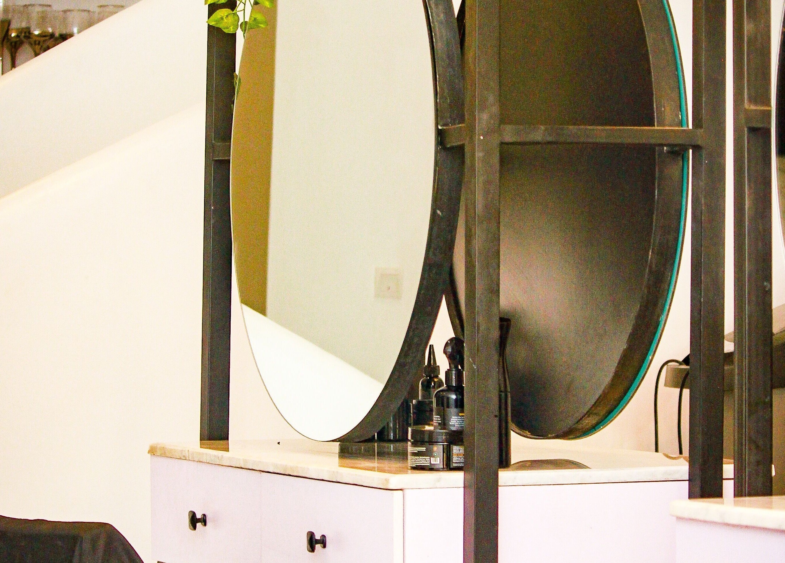 Elegant vanity at The Braiding Vault, Lekki, Lagos, NG showcasing a stylish mirror and chic decor.