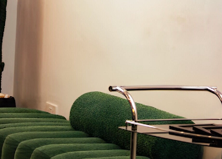 Chic green seating and sleek trolley at The Braiding Vault, Lekki, Lagos, NG, enhancing the spa's modern ambiance.