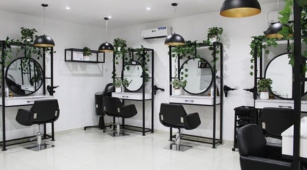 Chic salon setup at The Braiding Vault Signature, Lagos, Lagos, NG featuring modern stations with mirrors and plants.