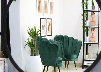 Elegant seating area in The Braiding Vault Signature, Lagos, Lagos, NG with green chairs and wall art.
