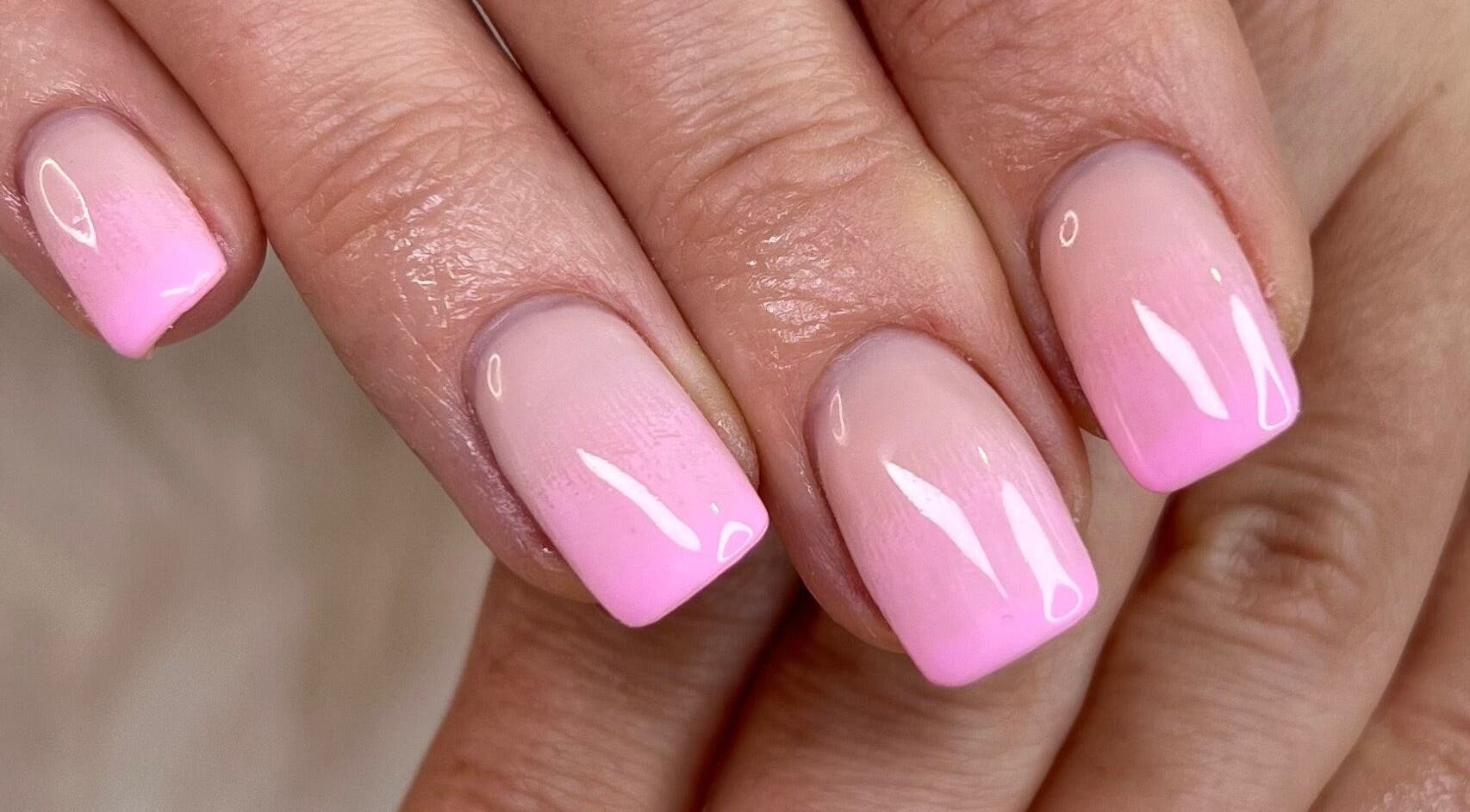 Elegant pink ombre manicure at Nanda Nails & Beauty, Bay Of Plenty, NZ, showcasing trendy nail design.