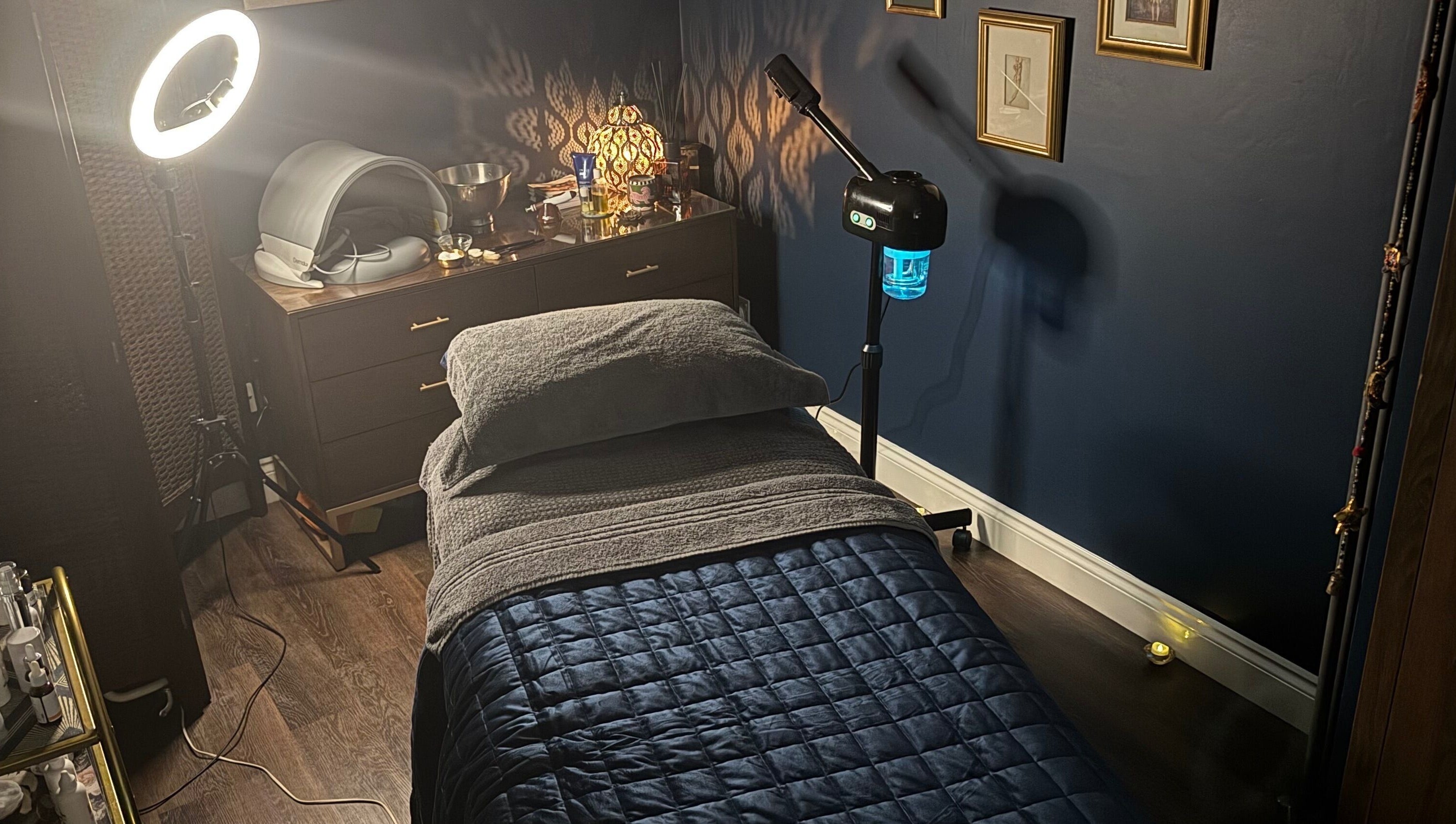 Cozy therapy room at Ritual in Glasgow, Scotland, GB, featuring soft lighting and a massage bed.