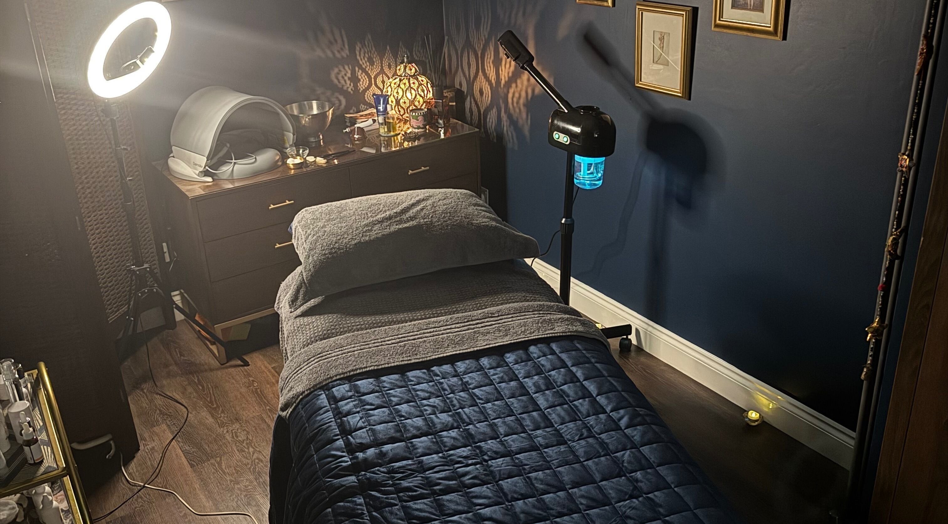 Cozy therapy room at Ritual in Glasgow, Scotland, GB, featuring soft lighting and a massage bed.
