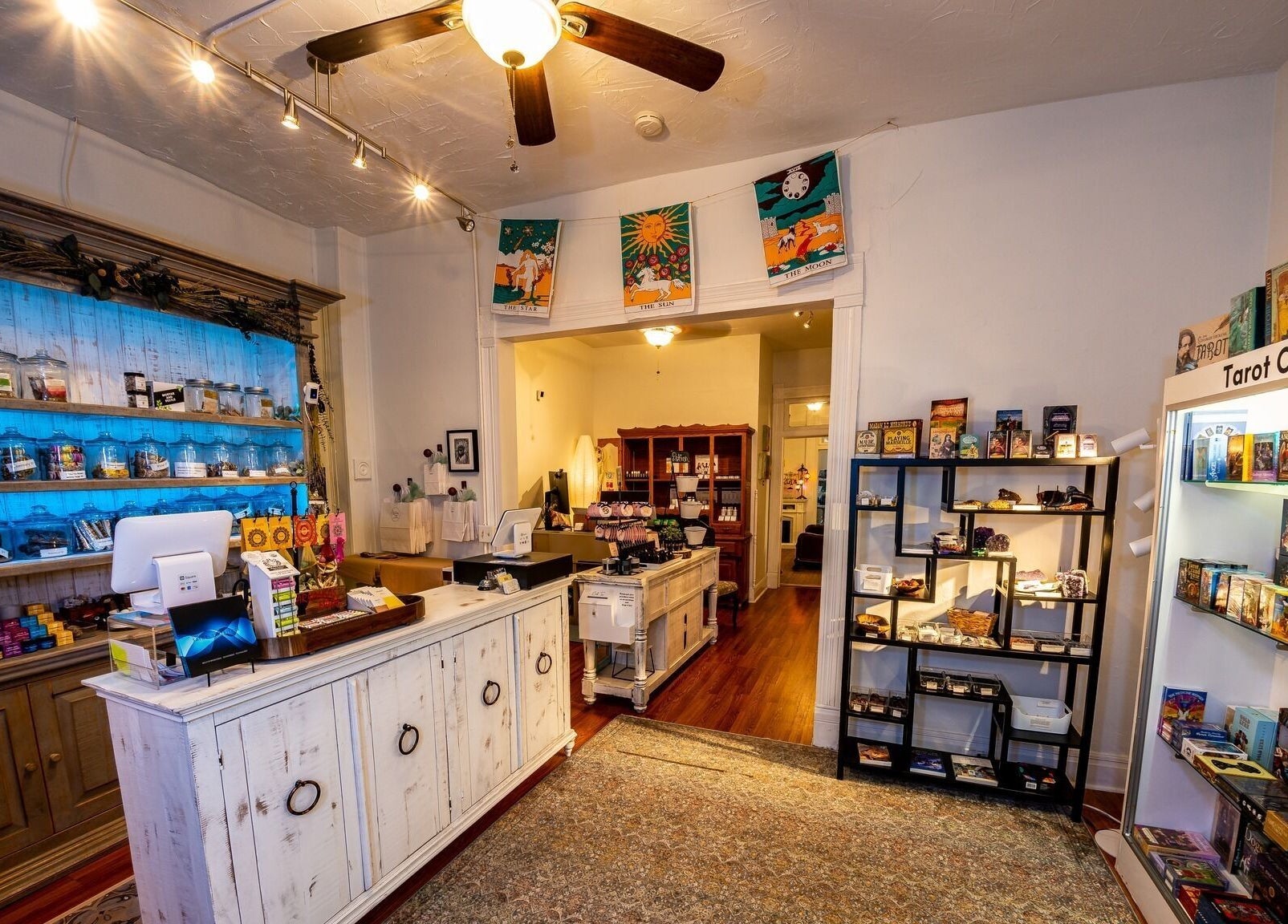 Inside Oracle & Sage - 78 Spring Street, Eureka Springs, Arkansas, US. Displays of tarot cards and wellness products.