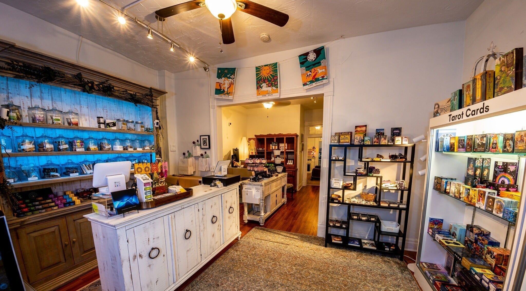 Inside Oracle & Sage - 78 Spring Street, Eureka Springs, Arkansas, US. Displays of tarot cards and wellness products.