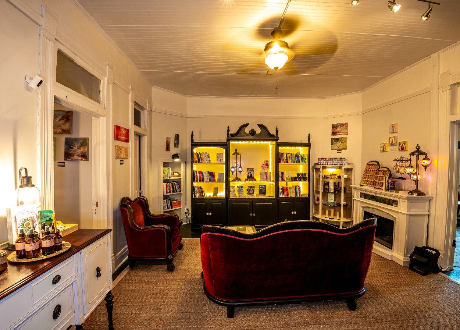 Elegant reading area with velvet sofas at Oracle & Sage - 78 Spring Street, Eureka Springs, Arkansas, US.