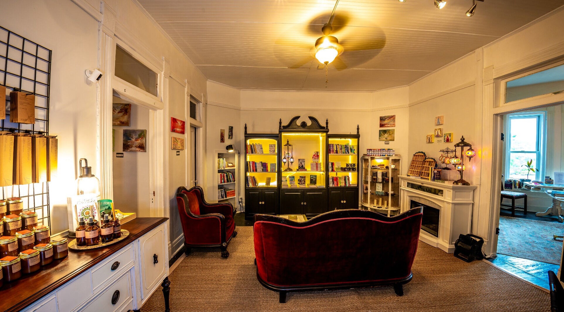 Elegant reading area with velvet sofas at Oracle & Sage - 78 Spring Street, Eureka Springs, Arkansas, US.