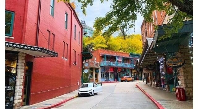 Picturesque street near Oracle & Sage - 78 Spring Street, Eureka Springs, Arkansas, US, showcasing vibrant buildings.