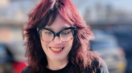 Smiling individual with stylish glasses at Rockin Rollers, Sierra Madre, California, US.