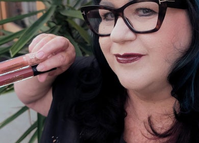 Woman showcasing lip gloss at Rockin Rollers, Sierra Madre, California, US.