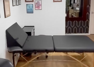 Cozy massage room at Bodiology Sussex in Eastbourne, England, GB with a massage table and calming decor.