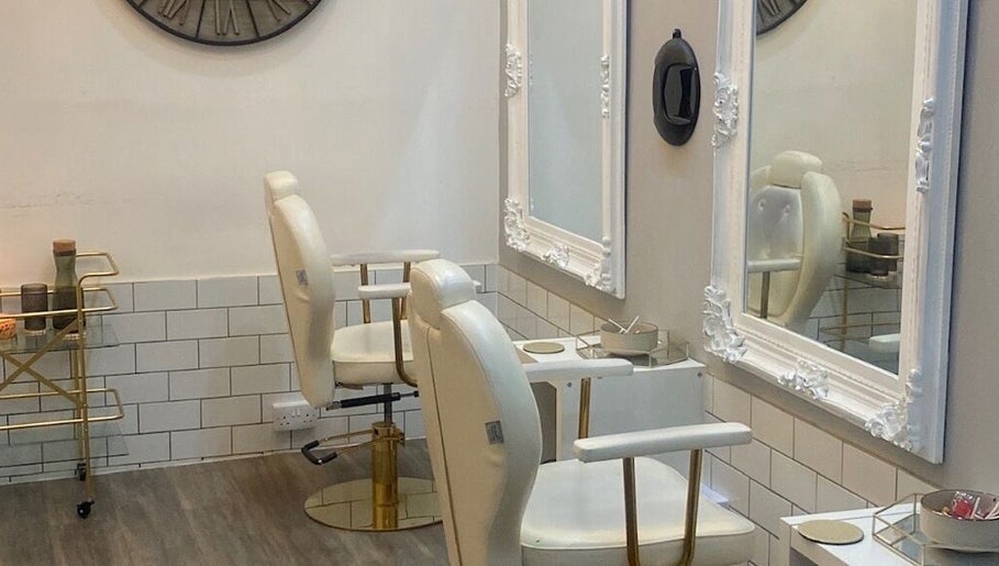 Elegant salon interior with white chairs at Bodiology Sussex, Eastbourne, England, GB.