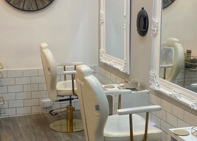 Elegant salon interior with white chairs at Bodiology Sussex, Eastbourne, England, GB.