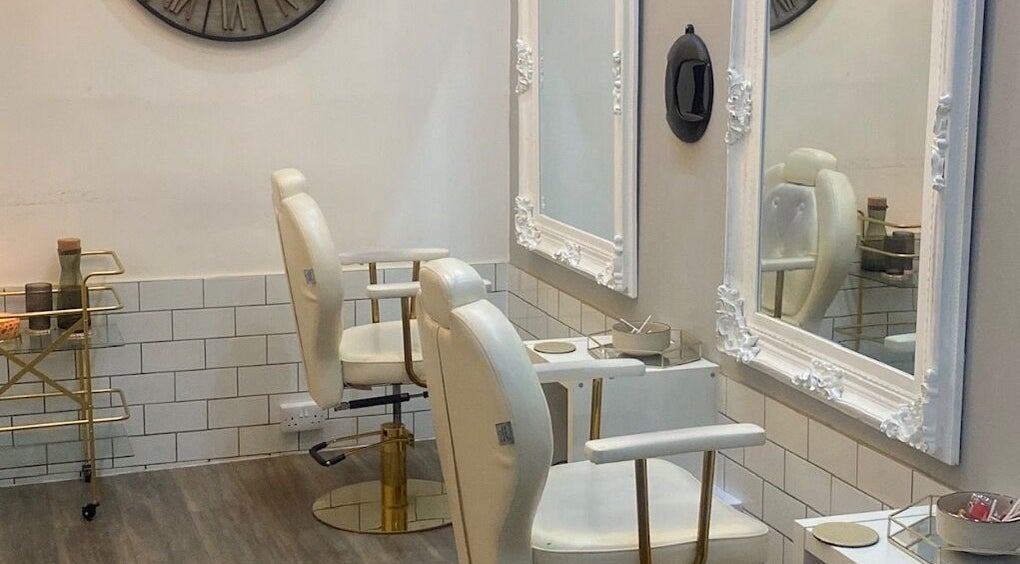 Elegant salon interior with white chairs at Bodiology Sussex, Eastbourne, England, GB.