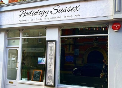 Front view of Bodiology Sussex, Eastbourne, England, GB, showcasing elegant signage and inviting storefront.