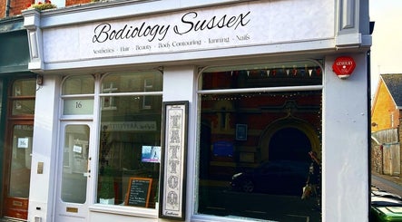 Front view of Bodiology Sussex, Eastbourne, England, GB, showcasing elegant signage and inviting storefront.
