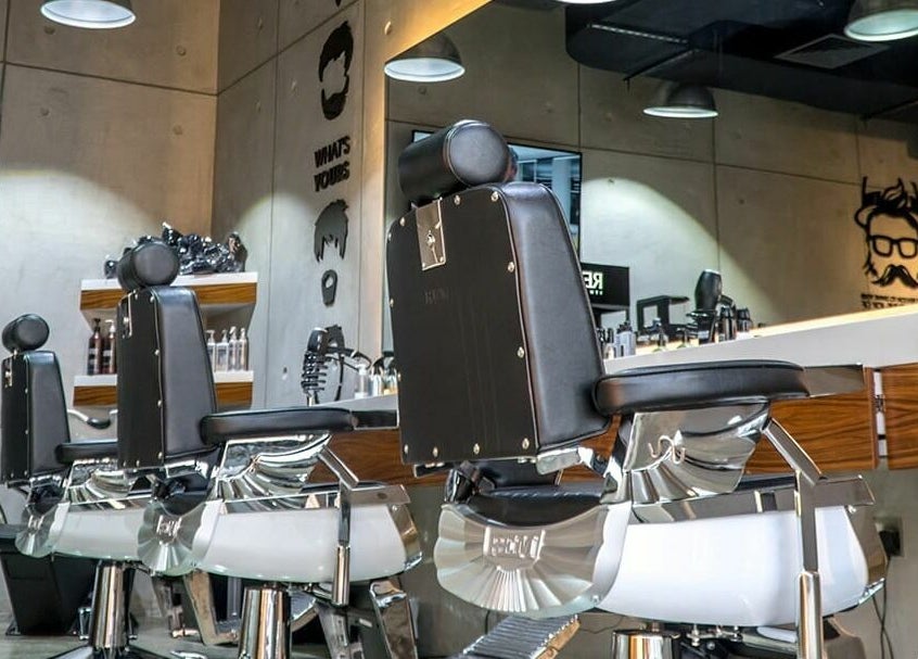 Modern barber chairs at Rerotti Gents Salon Remraam, Dubai, AE, showcasing luxury and style.