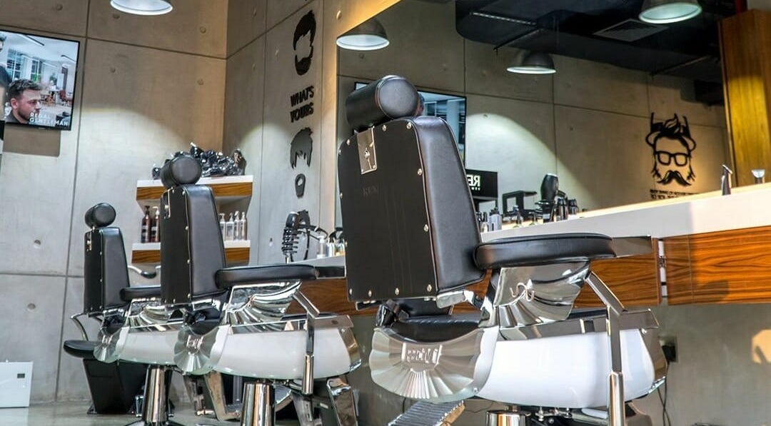 Modern barber chairs at Rerotti Gents Salon Remraam, Dubai, AE, showcasing luxury and style.