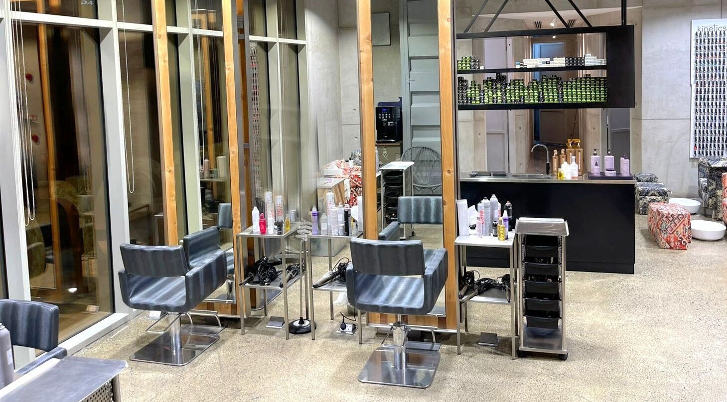 Modern salon interior at Rerotti Hair and Beauty - District 1, Dubai, AE showcasing stylish chairs and product displays.