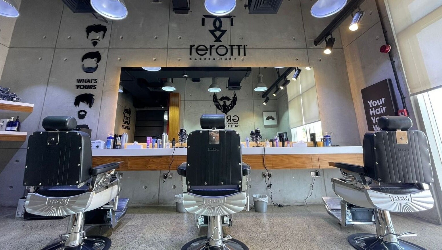 Sleek barber chairs at Rerotti Gents - Al Ghadeer in Abu Dhabi, AE, showcasing a contemporary interior.