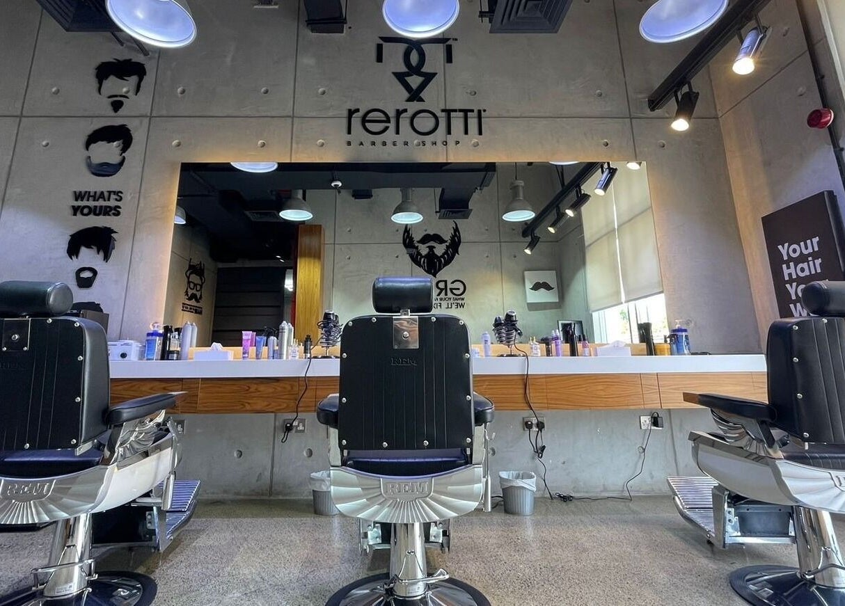 Sleek barber chairs at Rerotti Gents - Al Ghadeer in Abu Dhabi, AE, showcasing a contemporary interior.