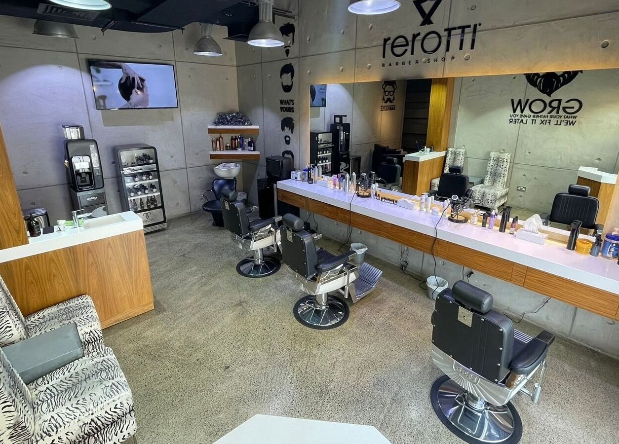 Interior of Rerotti Gents - Al Ghadeer, Abu Dhabi, AE: sleek chairs, mirrors, and grooming products.