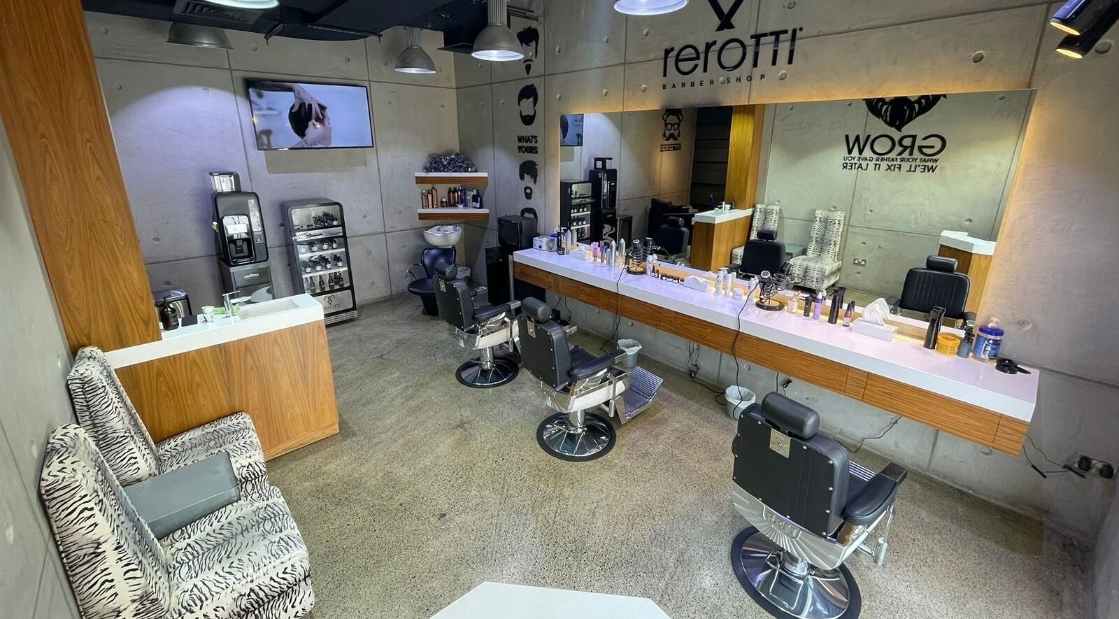 Interior of Rerotti Gents - Al Ghadeer, Abu Dhabi, AE: sleek chairs, mirrors, and grooming products.
