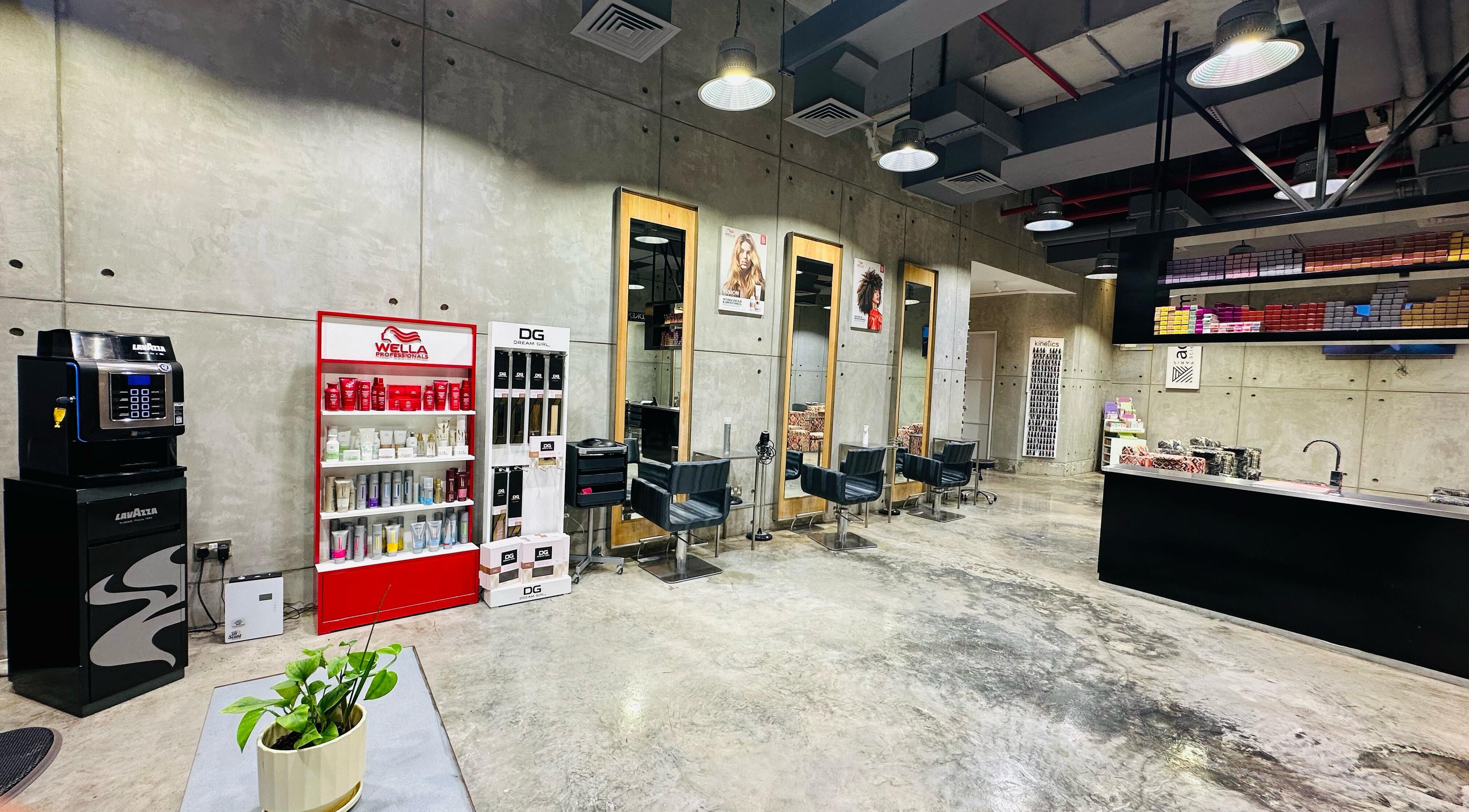 Modern interior of Rerotti Hair and Beauty - Al Ghadeer, Abu Dhabi showcasing sleek salon chairs and product displays.