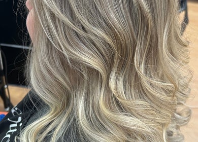 Stylish blonde waves created at Erin McQuitty Hair in Carrickfergus, England, GB showcase expert styling.