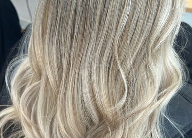 Blonde hair styled at Erin McQuitty Hair in Carrickfergus, England, GB. Showcasing smooth waves and highlights.