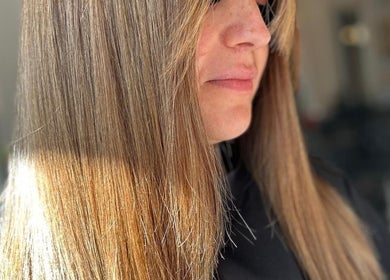 Smooth, glossy hair styled at Erin McQuitty Hair in Carrickfergus, England, GB, reflecting light beautifully.