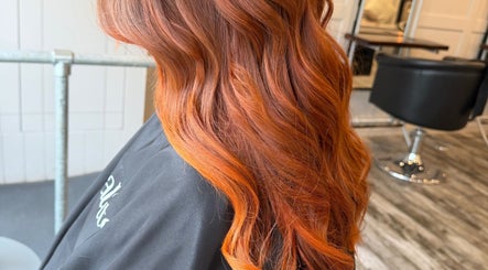 Vibrant orange hair styled at Erin McQuitty Hair, Carrickfergus, England, GB salon interior.