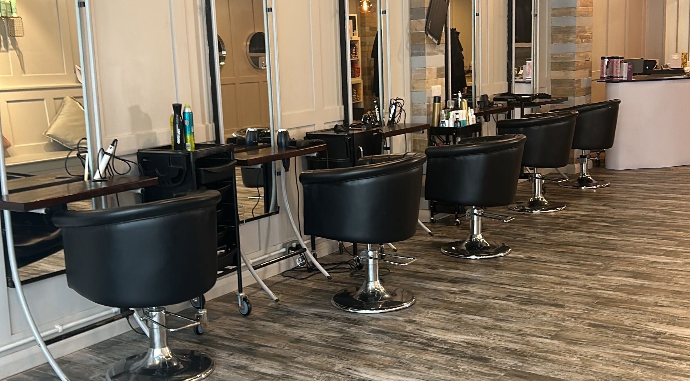 Elegant salon setup at Erin & Co Hair/Beauty, Carrickfergus, Northern Ireland, GB displaying stylish black chairs.