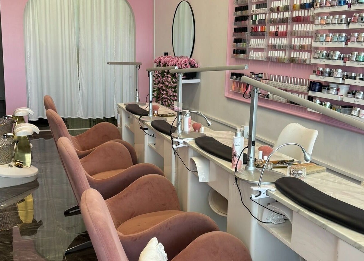 Elegant nail spa at Fearless Beauty, Auckland, Auckland, NZ with plush chairs and vibrant polish display.